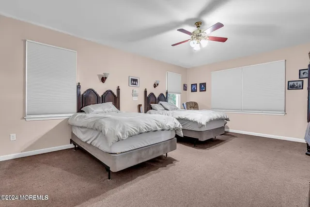 a spacious bedroom with a bed and a chandelier