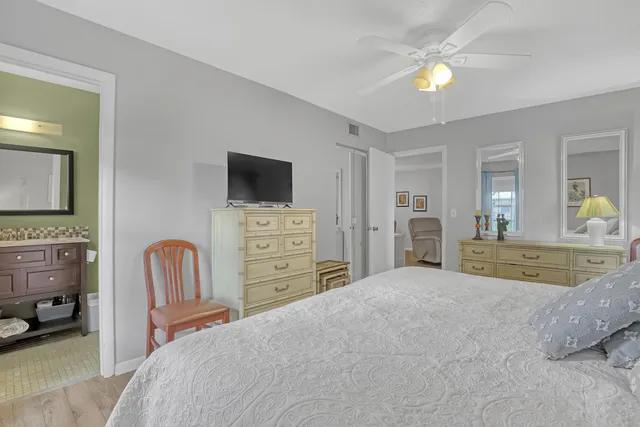 a bathroom with a toilet sink vanity and mirror