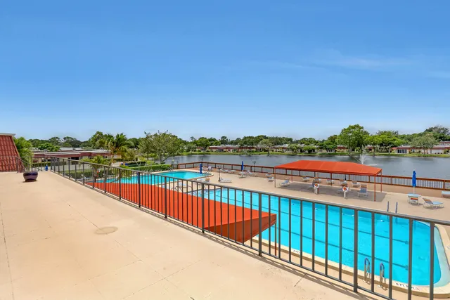 a swimming pool with outdoor seating and yard
