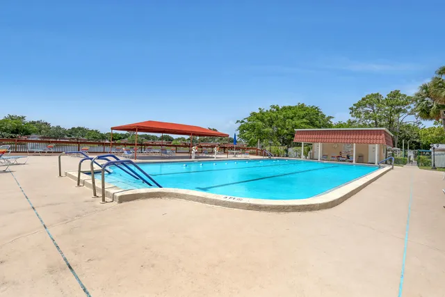 a swimming pool with outdoor seating and yard