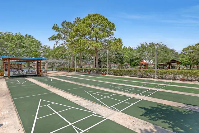 a view of a patio with a table and chairs and couches with wooden fence