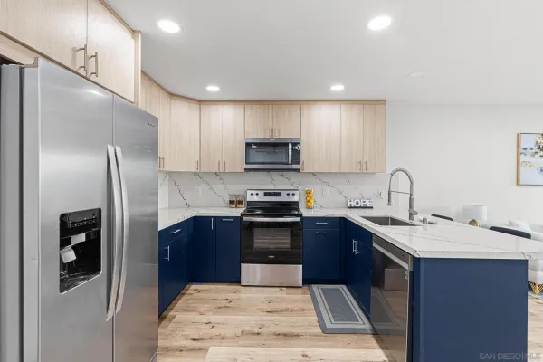 a kitchen with stainless steel appliances granite countertop a refrigerator and a sink