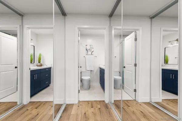 a view of a bathroom with tub mirror and bathroom