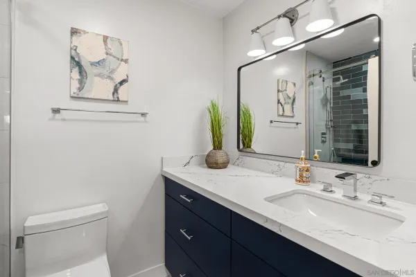 a bathroom with a double vanity sink and a mirror