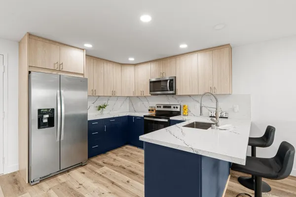 a kitchen with a refrigerator a sink a stove a microwave and cabinets