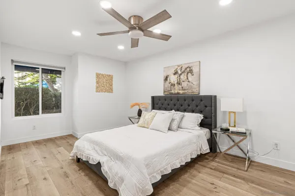 a bedroom with a large bed and a window