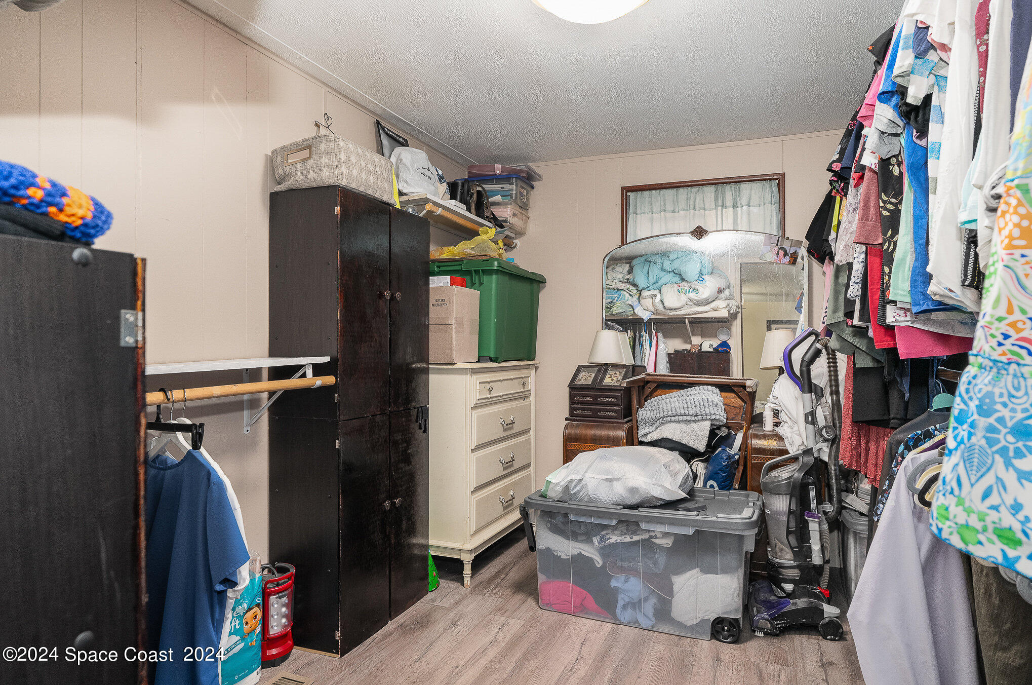 385 Ronald Street Cocoa, FL 32927 - Photo 12 of 24 a living room with furniture a flat screen tv and a refrigerator