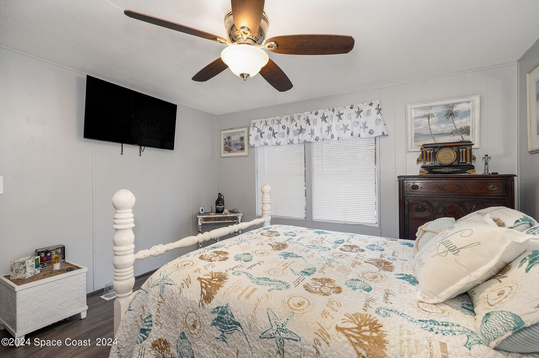 385 Ronald Street Cocoa, FL 32927 - Photo 14 of 24 a bedroom with a bed window and a flat screen tv