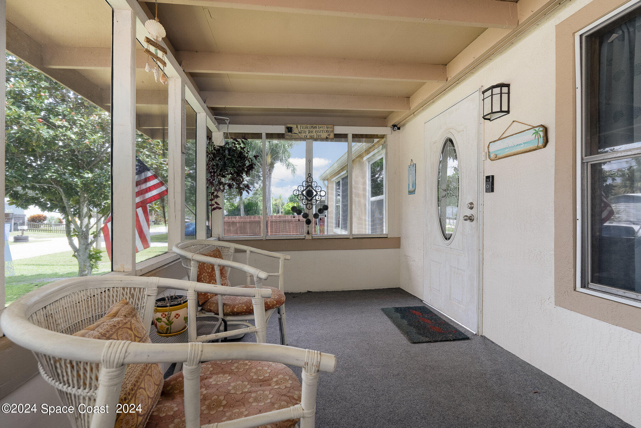 385 Ronald Street Cocoa, FL 32927 - Photo 17 of 24 a view of living room kitchen with furniture and window