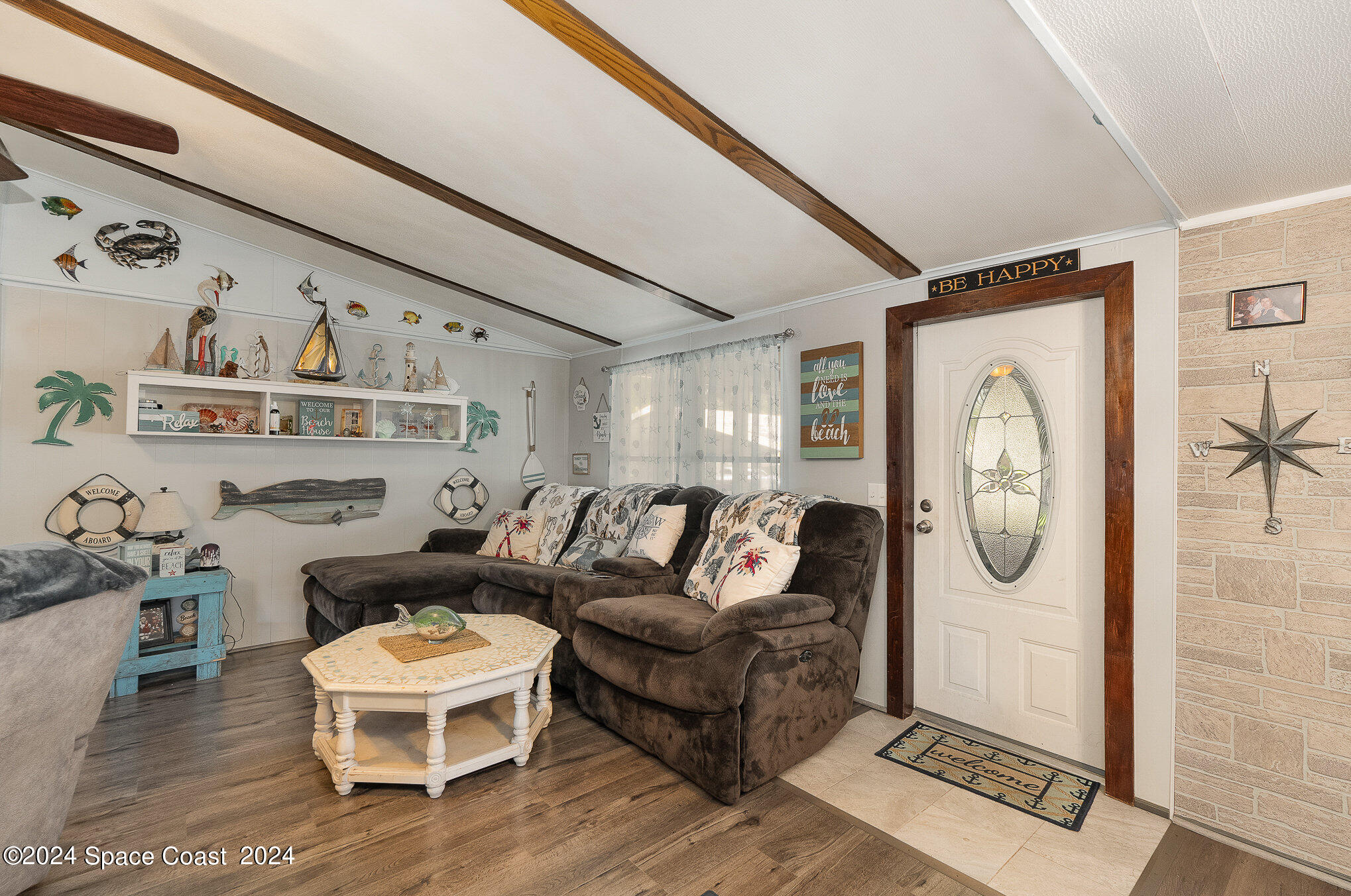385 Ronald Street Cocoa, FL 32927 - Photo 2 of 24 a living room with furniture a rug and a window