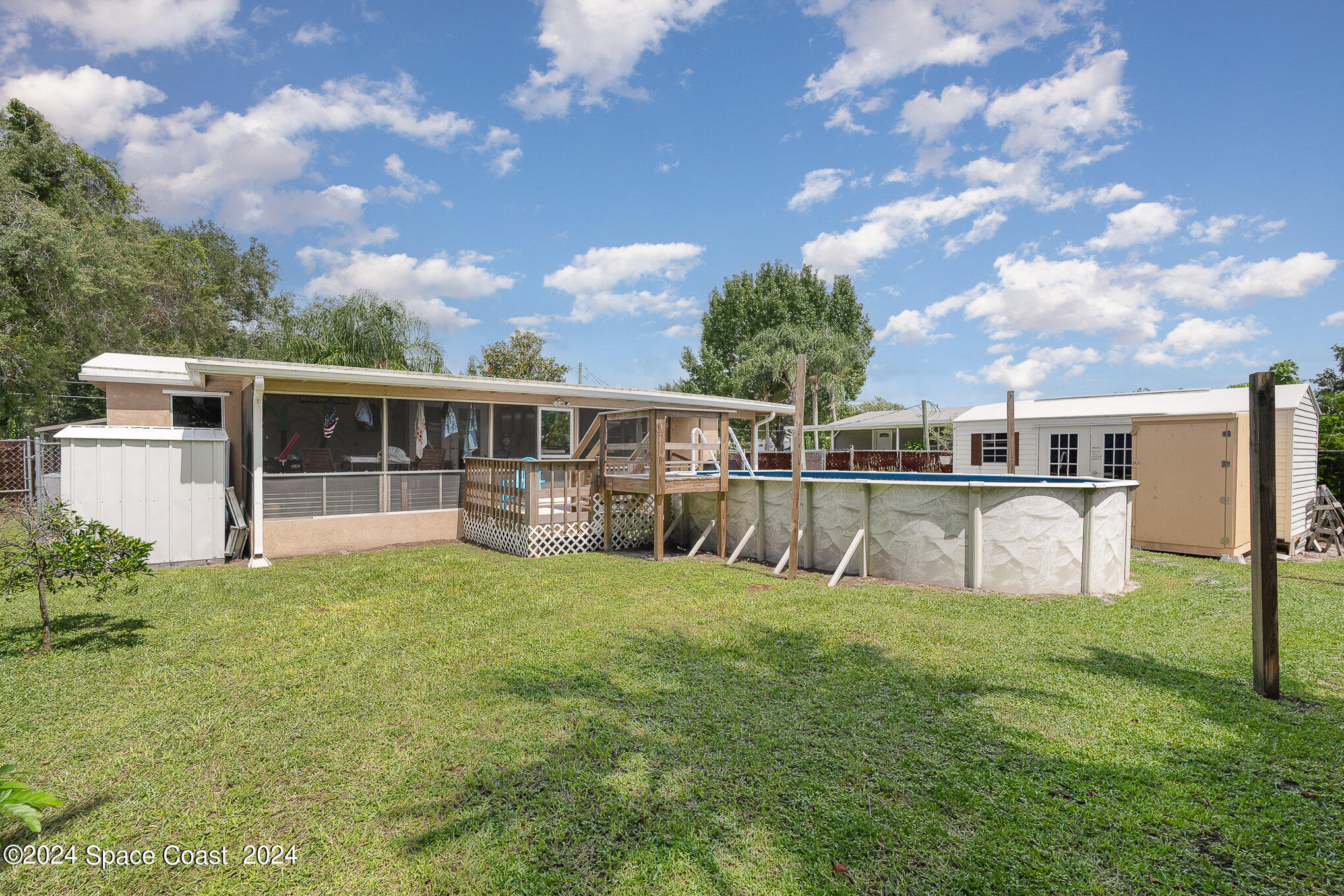 385 Ronald Street Cocoa, FL 32927 - Photo 24 of 24 a view of a house with swimming pool and a yard