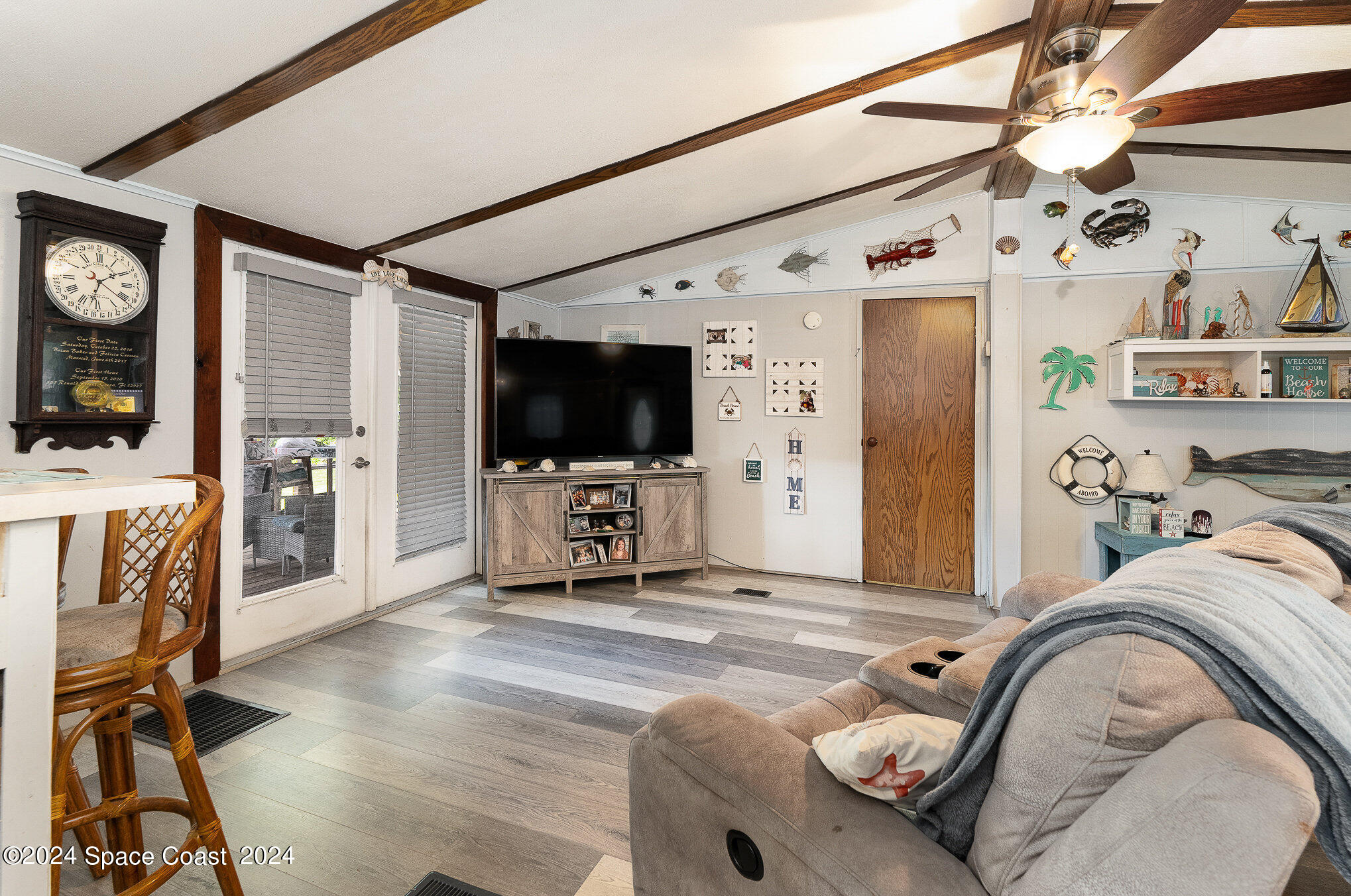 385 Ronald Street Cocoa, FL 32927 - Photo 3 of 24 a living room with furniture and a flat screen tv