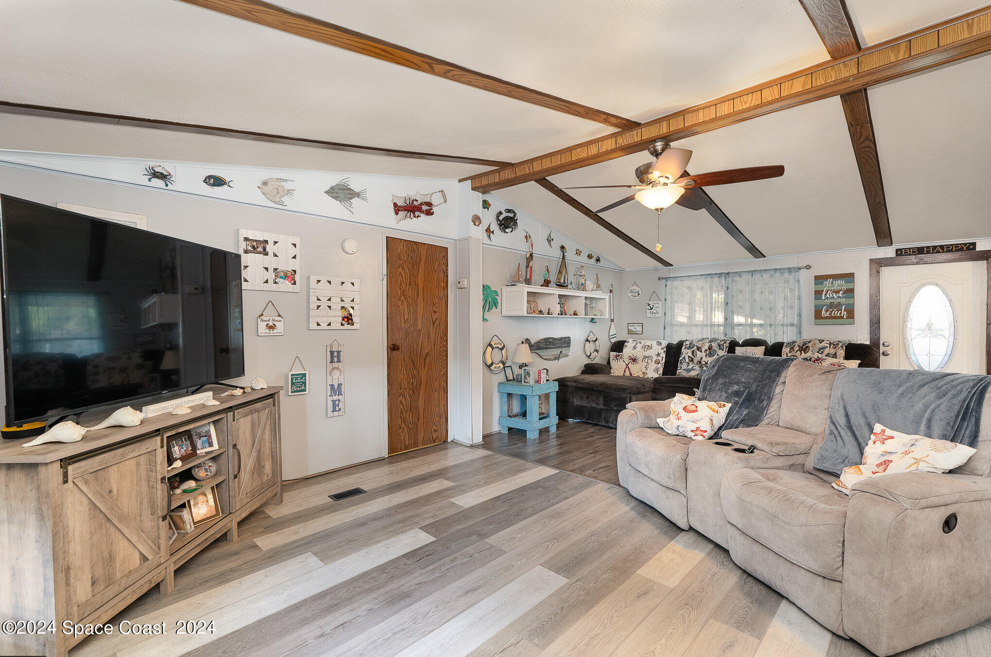 385 Ronald Street Cocoa, FL 32927 - Photo 4 of 24 a living room with furniture and a flat screen tv