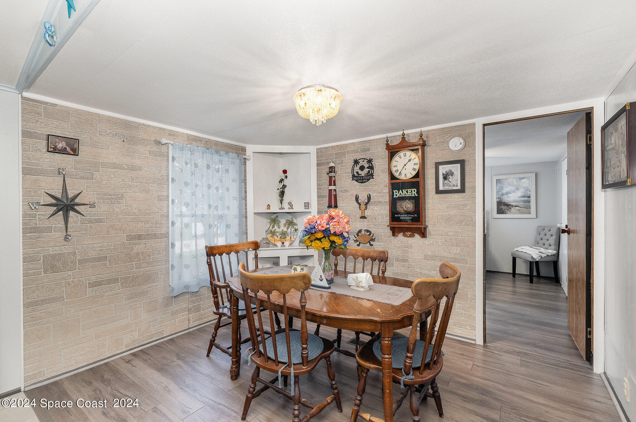 385 Ronald Street Cocoa, FL 32927 - Photo 5 of 24 a view of a dining room with furniture and wooden floor