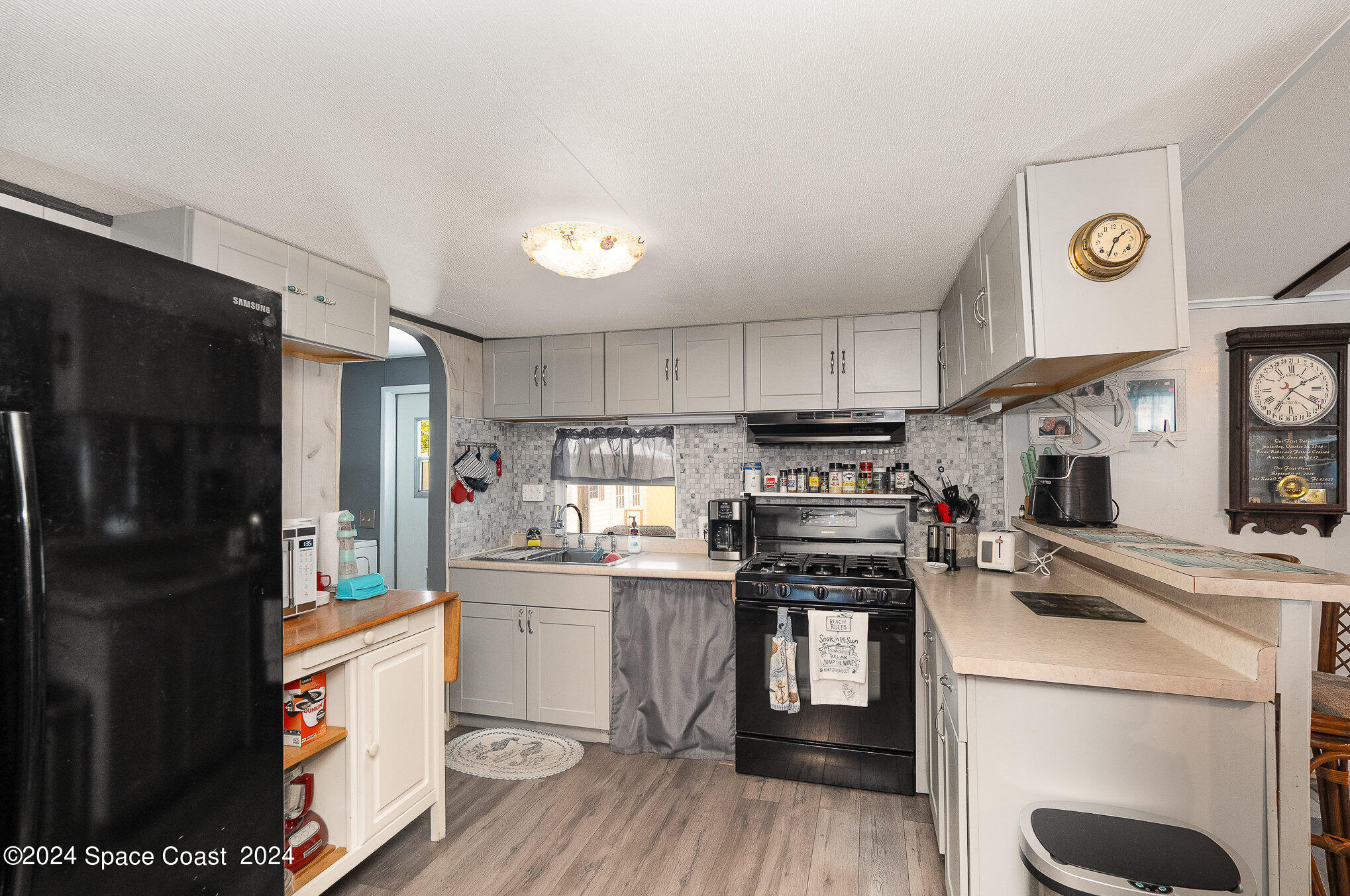 385 Ronald Street Cocoa, FL 32927 - Photo 6 of 24 a kitchen with a refrigerator a stove top oven a sink and dishwasher