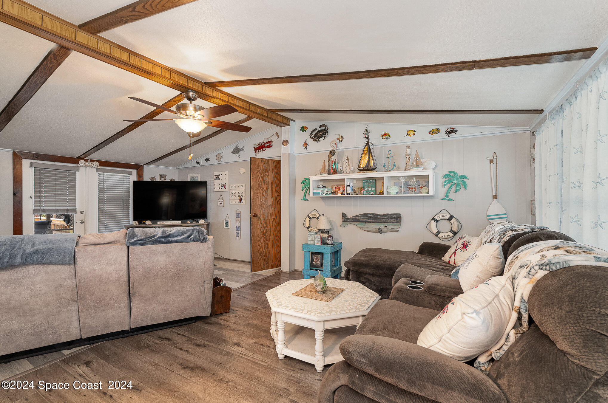 385 Ronald Street Cocoa, FL 32927 - Photo 8 of 24 a living room with furniture and a flat screen tv
