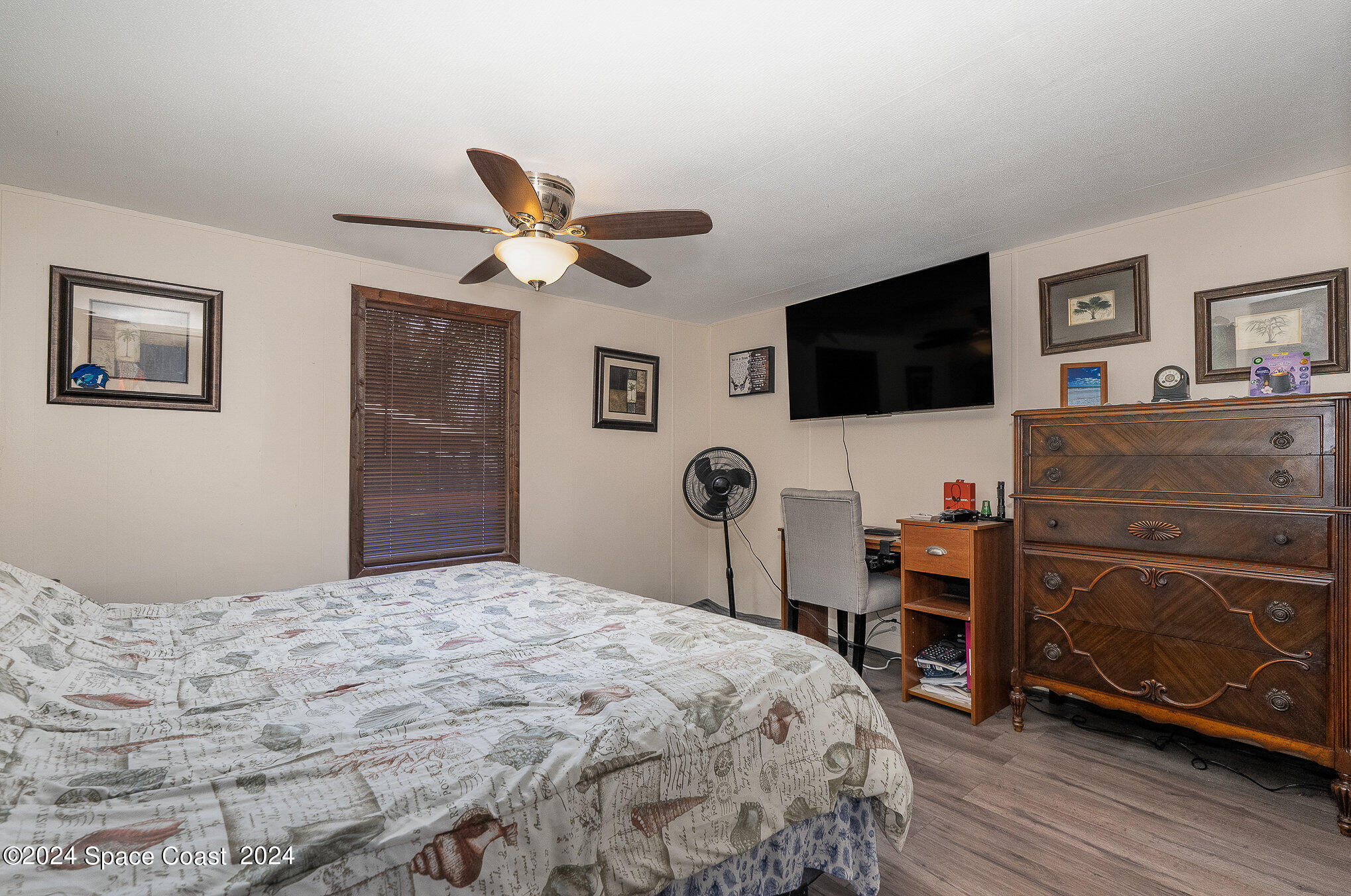 385 Ronald Street Cocoa, FL 32927 - Photo 10 of 24 a bedroom with a bed and a flat screen tv