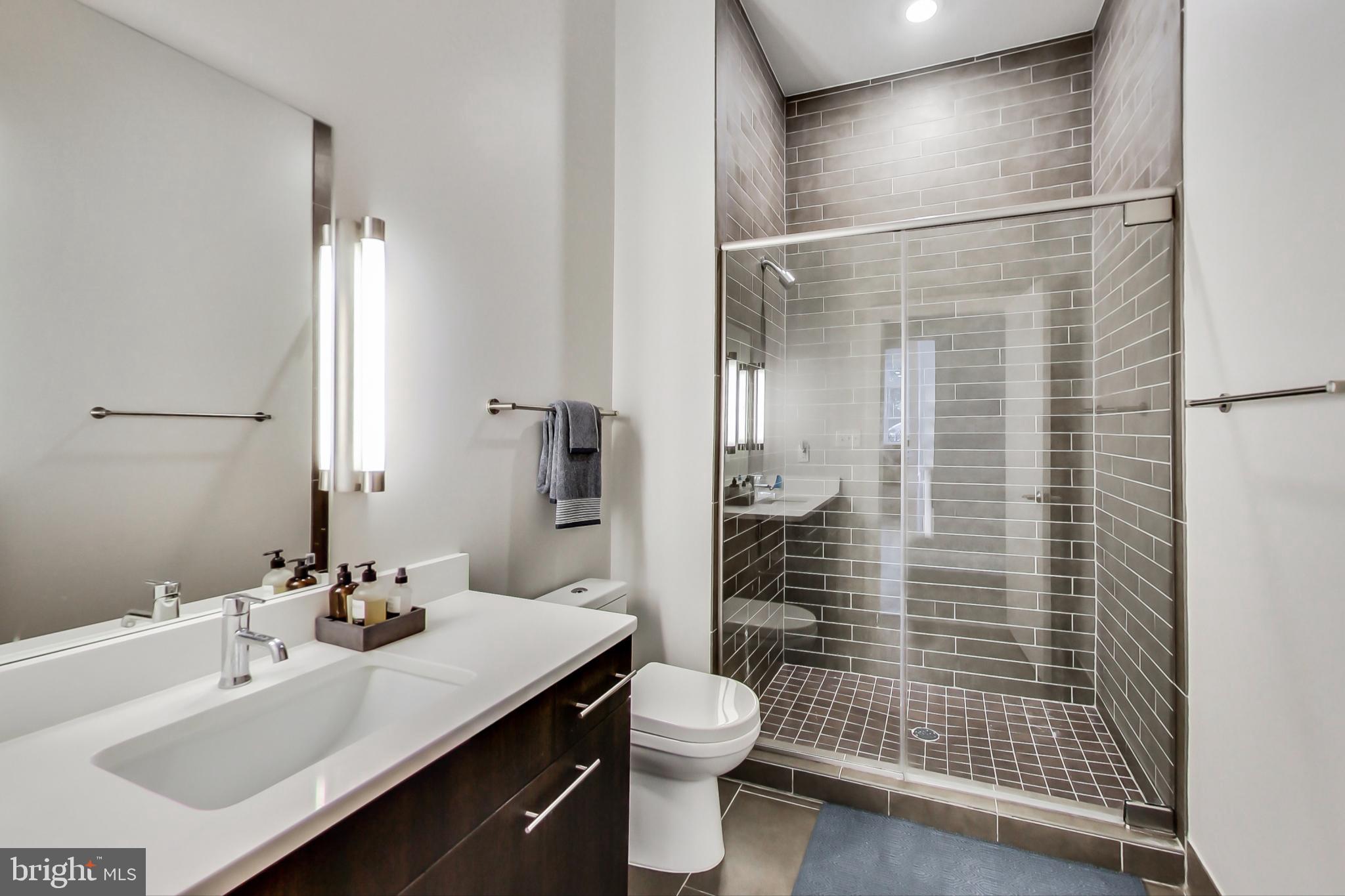 1767 Lanier Place Northwest, Unit 2 Washington, DC 20009 - Photo 11 of 19 a bathroom with a sink toilet and shower
