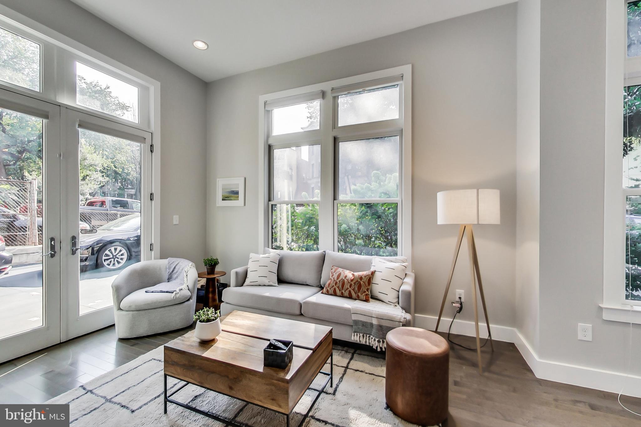 1767 Lanier Place Northwest, Unit 2 Washington, DC 20009 - Photo 2 of 19 a living room with furniture and a large window