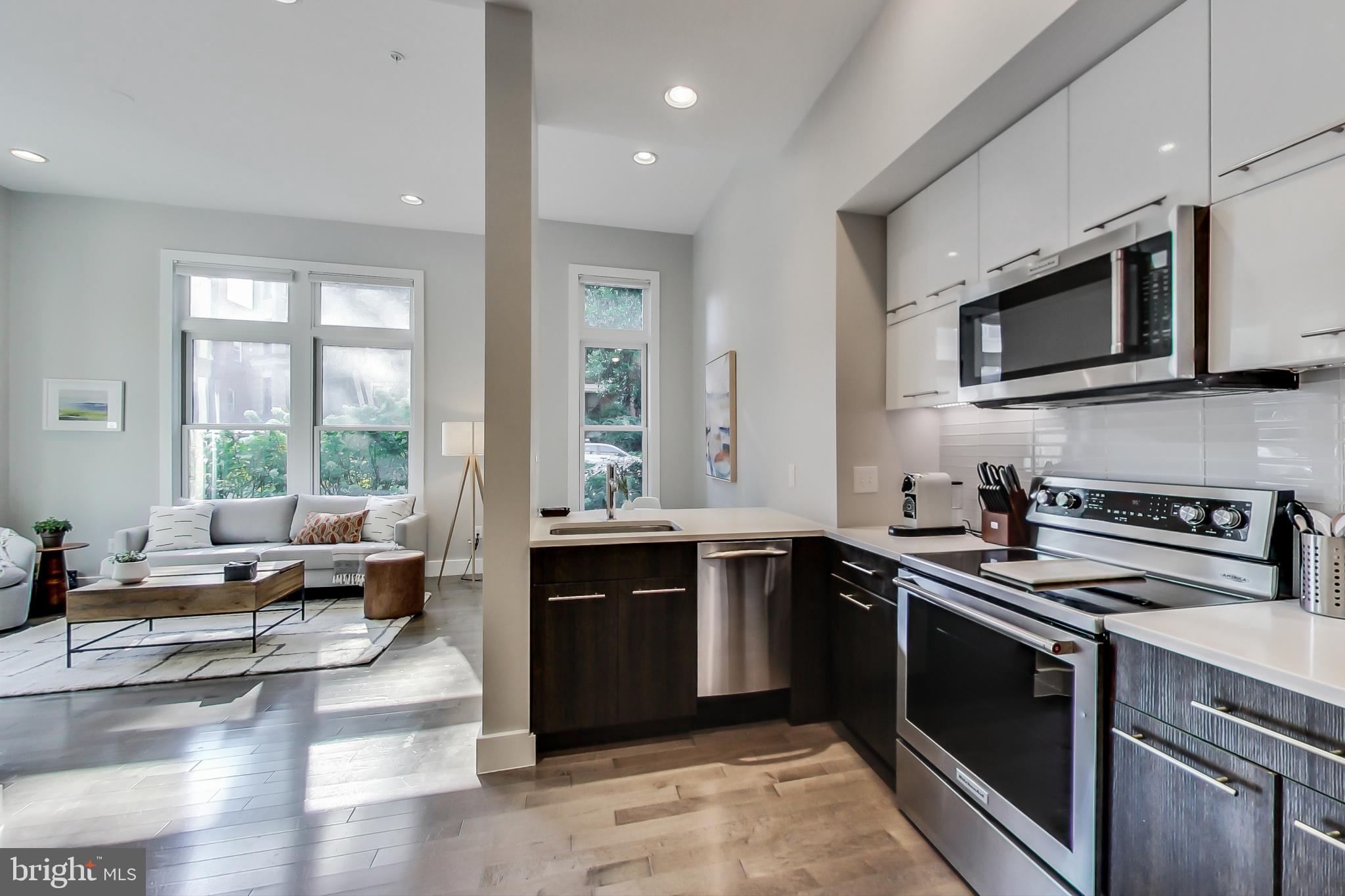 1767 Lanier Place Northwest, Unit 2 Washington, DC 20009 - Photo 4 of 19 a kitchen with stainless steel appliances granite countertop a stove and a sink