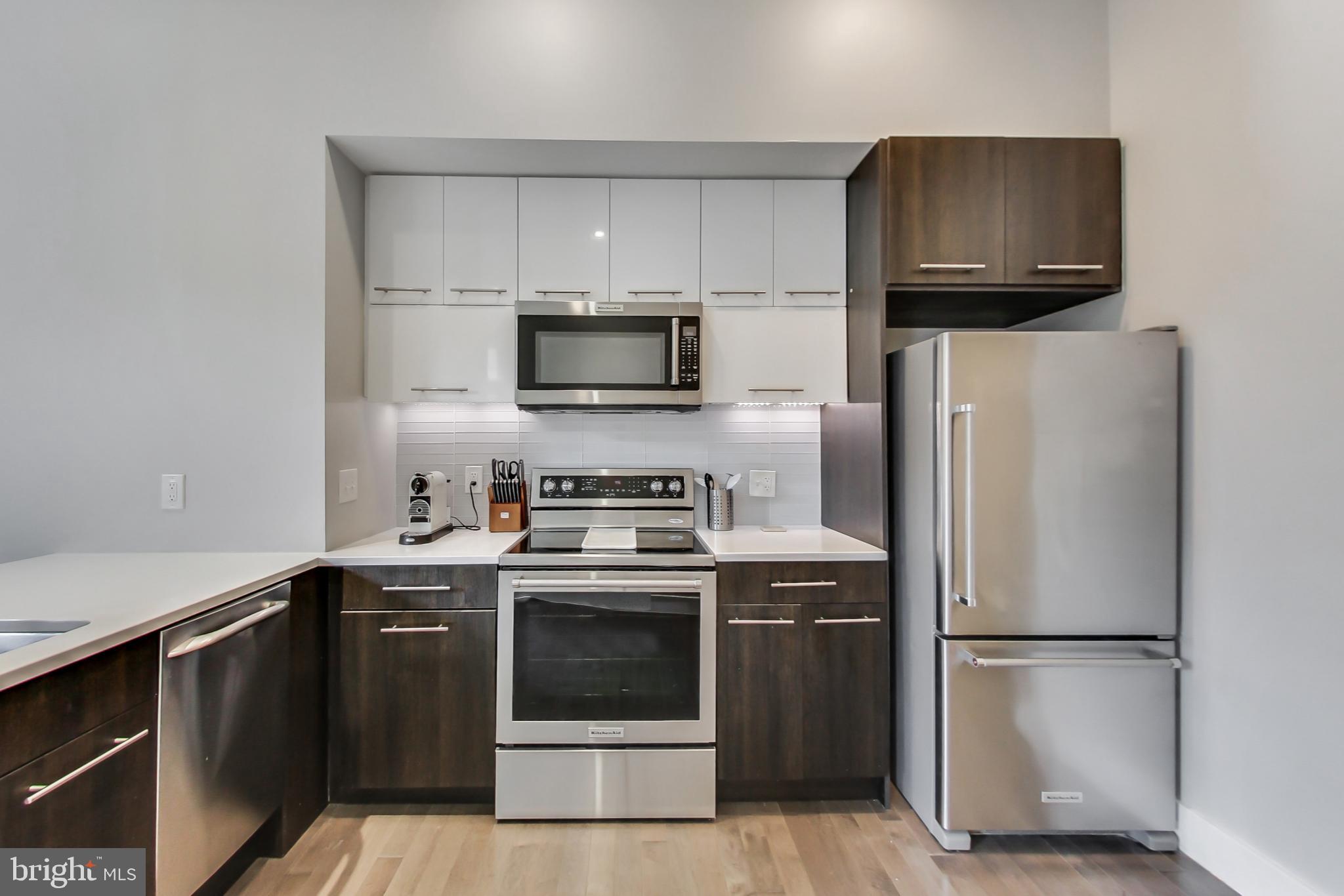 1767 Lanier Place Northwest, Unit 2 Washington, DC 20009 - Photo 5 of 19 a kitchen with a refrigerator sink and microwave
