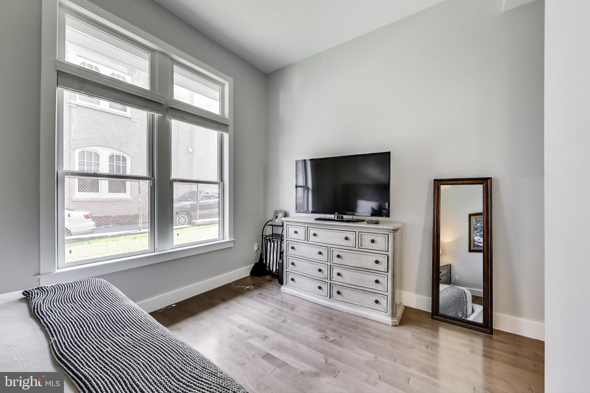 1767 Lanier Place Northwest, Unit 2 Washington, DC 20009 - Photo 10 of 19 a living room with furniture and a flat screen tv