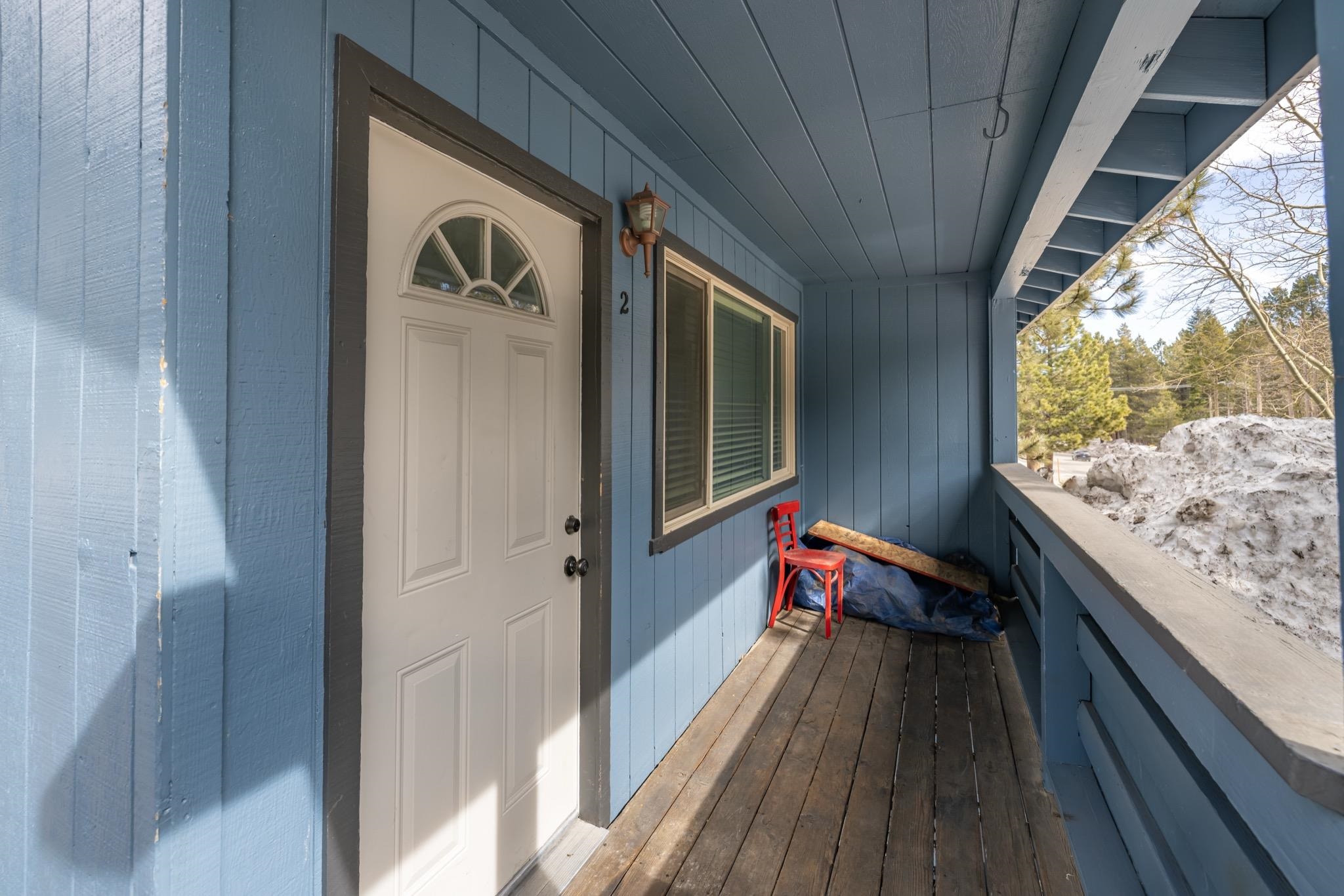 541 Mono Street, Unit 2 Mammoth Lakes, CA 93546 - Photo 2 of 16 a balcony view with wooden floor and furniture