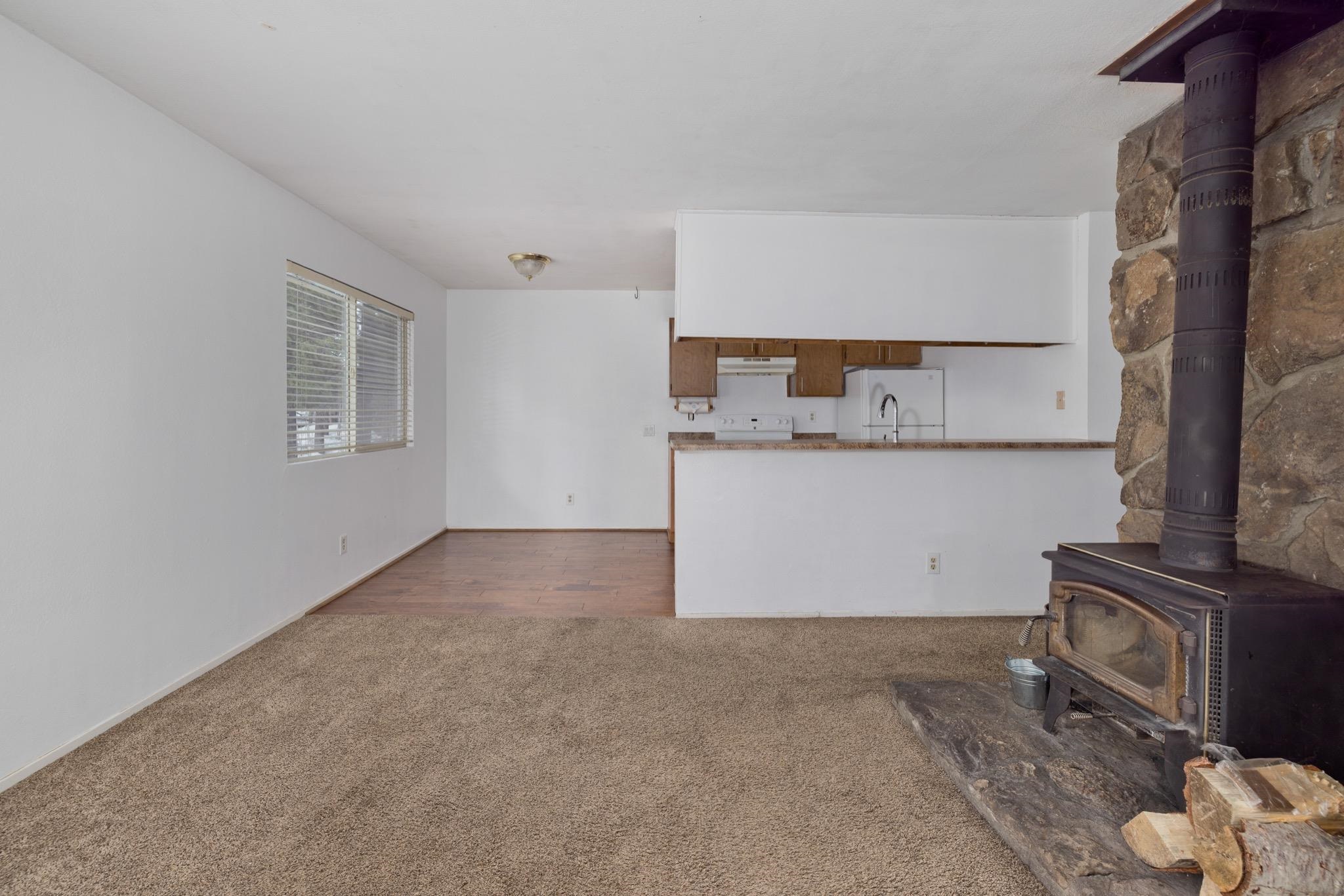 541 Mono Street, Unit 2 Mammoth Lakes, CA 93546 - Photo 7 of 16 a view of a kitchen with furniture and a fireplace