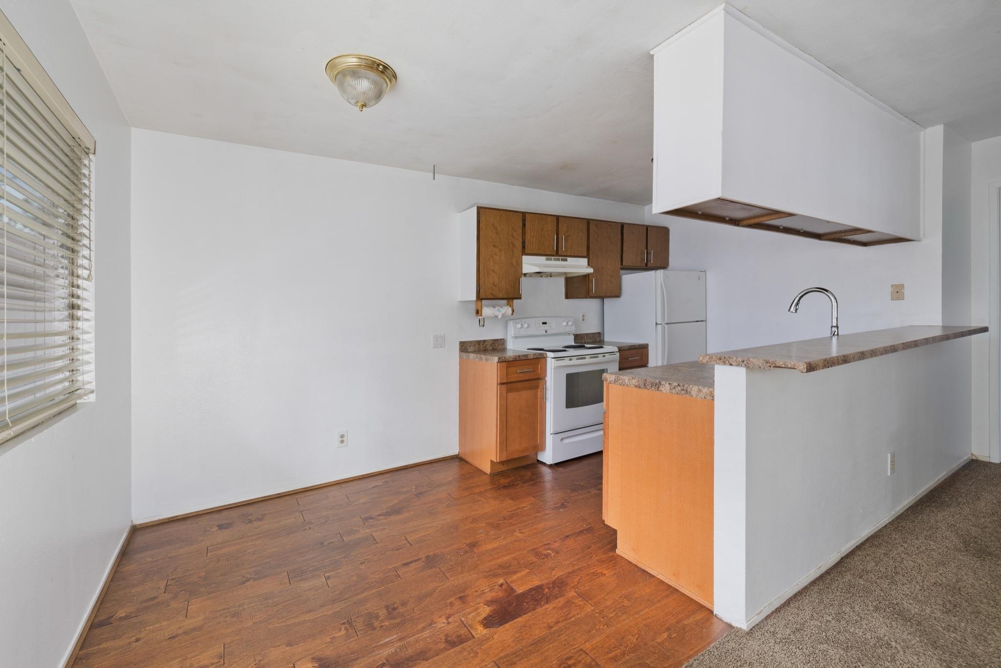 541 Mono Street, Unit 2 Mammoth Lakes, CA 93546 - Photo 8 of 16 a kitchen with a sink cabinets and window