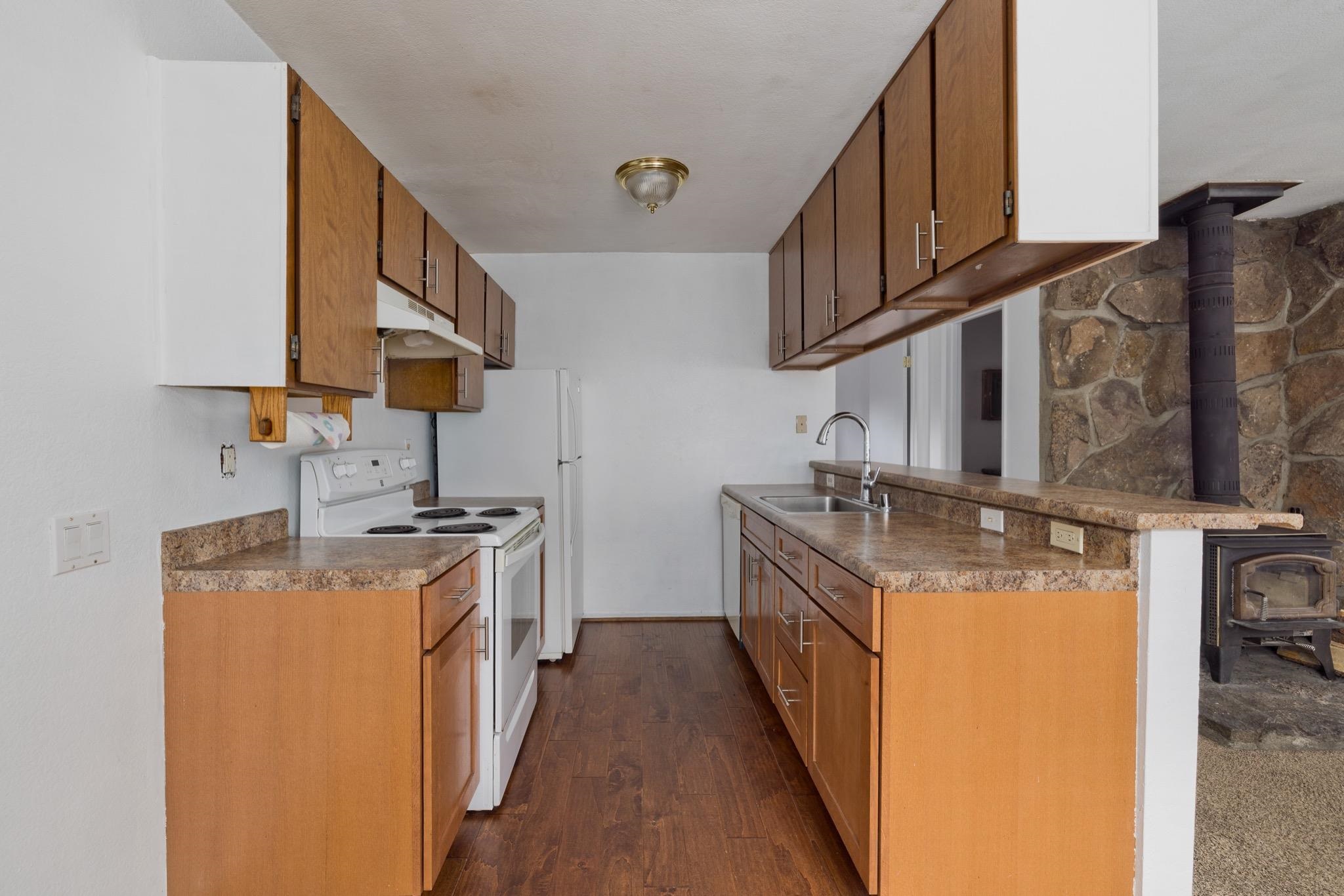 541 Mono Street, Unit 2 Mammoth Lakes, CA 93546 - Photo 9 of 16 a kitchen with a sink stove and cabinets