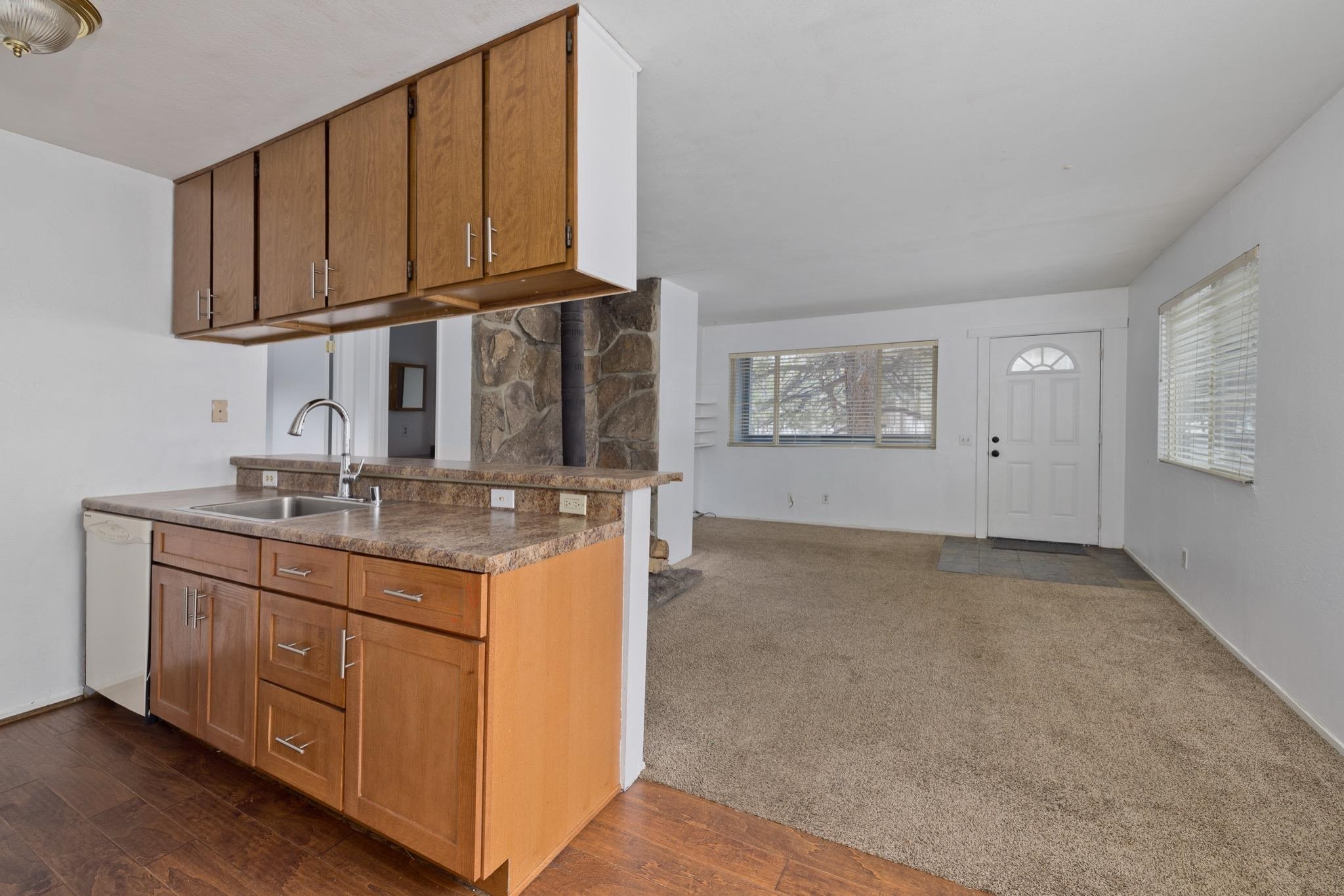 541 Mono Street, Unit 2 Mammoth Lakes, CA 93546 - Photo 16 of 16 a kitchen with stainless steel appliances granite countertop a sink stove and cabinets