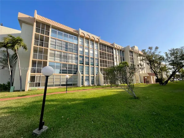a view of an apartment with a backyard