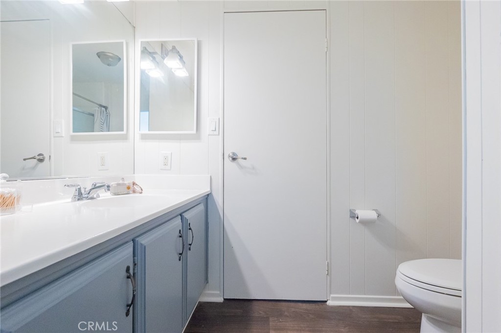 1134 Villa Calimesa Lane, Unit 106 Calimesa, CA 92320 - Photo 11 of 22 a bathroom with a sink a toilet and a mirror