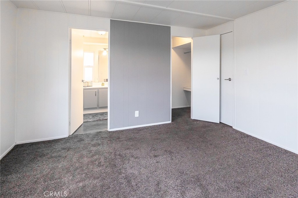 1134 Villa Calimesa Lane, Unit 106 Calimesa, CA 92320 - Photo 13 of 22 an empty room with windows and bathroom view