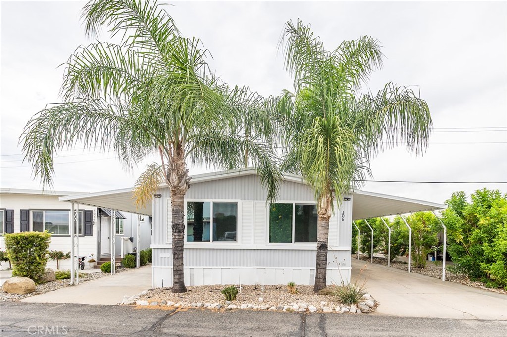 1134 Villa Calimesa Lane, Unit 106 Calimesa, CA 92320 - Photo 2 of 22 a front view of a house with a tree