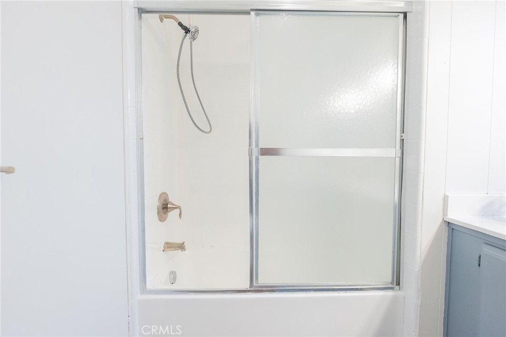 1134 Villa Calimesa Lane, Unit 106 Calimesa, CA 92320 - Photo 9 of 22 a bathroom with a glass shower door