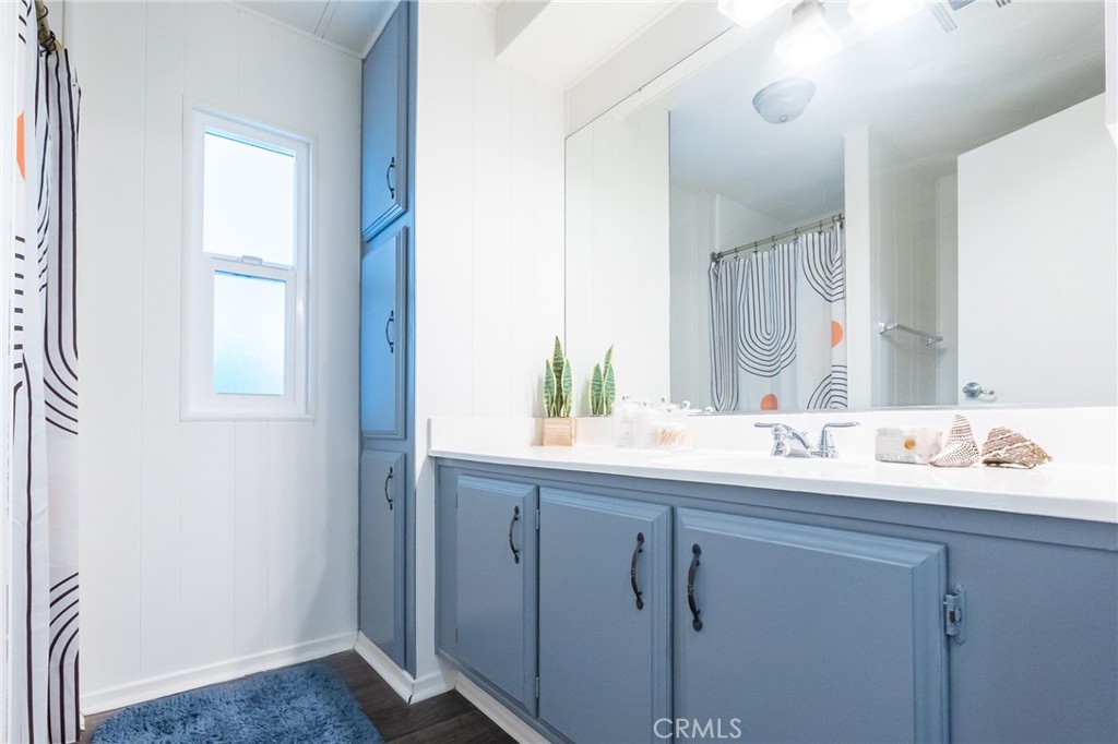1134 Villa Calimesa Lane, Unit 106 Calimesa, CA 92320 - Photo 10 of 22 a bathroom with a double vanity sink and a mirror