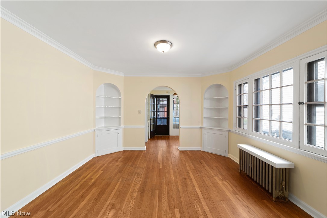 3666 Winchell Road Beachwood, OH 44122 - Photo 14 of 46 Unfurnished room featuring built in shelves, hardwood / wood-style flooring, and radiator