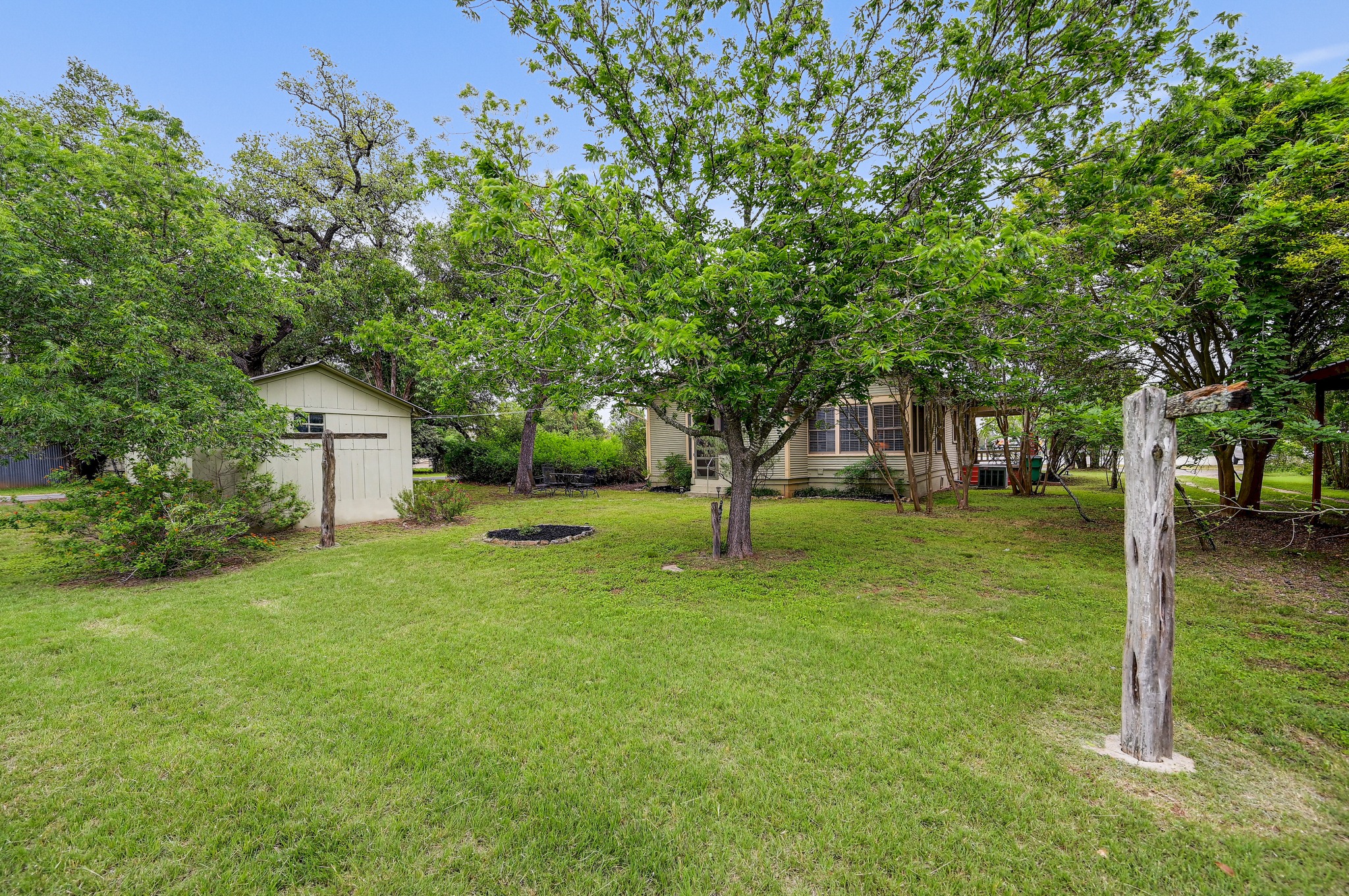 719 Elm Street Blanco, TX 78606 - Photo 21 of 25 Expansive green lawn with mature trees providing natural shade