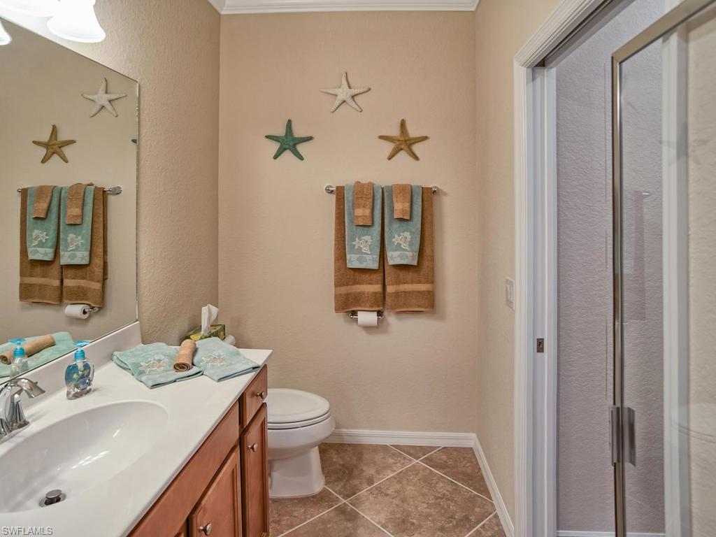 9560 Trevi Court, Unit 4842 Naples, FL 34113 - Photo 12 of 25 a bathroom with a sink toilet and shower