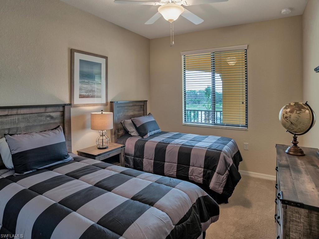 9560 Trevi Court, Unit 4842 Naples, FL 34113 - Photo 13 of 25 a bedroom with a bed and window
