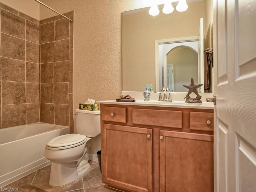 9560 Trevi Court, Unit 4842 Naples, FL 34113 - Photo 14 of 25 a bathroom with a sink a toilet and shower