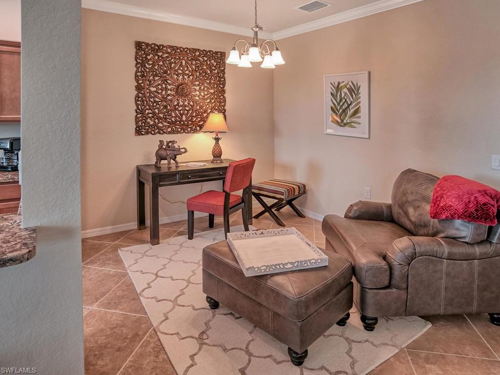 9560 Trevi Court, Unit 4842 Naples, FL 34113 - Photo 5 of 25 a living room with furniture and a chandelier