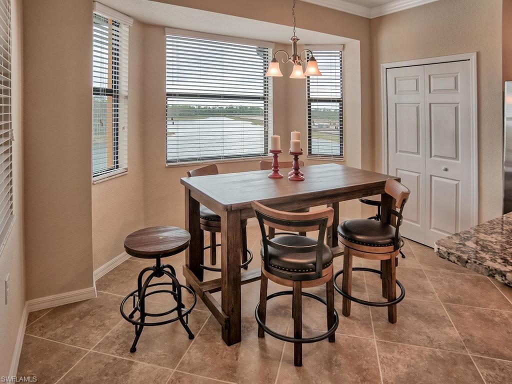 9560 Trevi Court, Unit 4842 Naples, FL 34113 - Photo 8 of 25 a view of a dining room with furniture and window