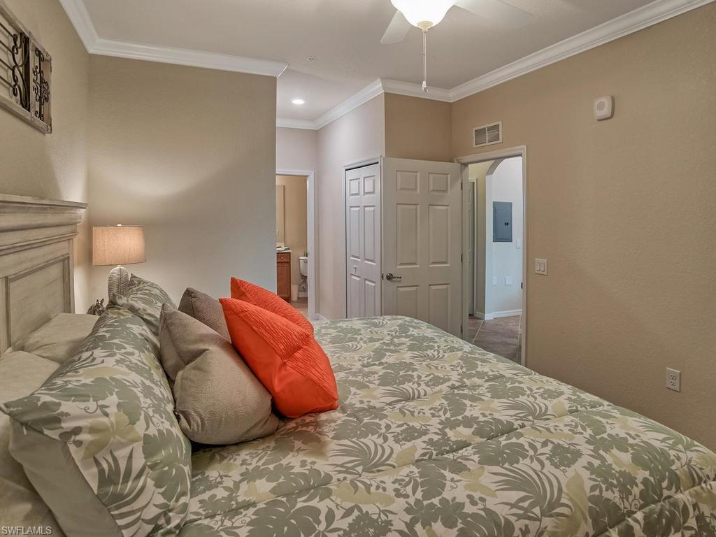 9560 Trevi Court, Unit 4842 Naples, FL 34113 - Photo 10 of 25 a bed room with a bed and a couch