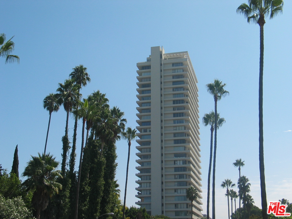 9255 Doheny Road, Unit 902 West Hollywood, CA 90069 - Photo 2 of 47 a view of a tall building with a palm tree in the background