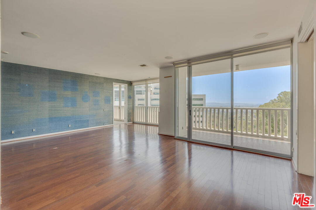 9255 Doheny Road, Unit 902 West Hollywood, CA 90069 - Photo 14 of 47 a view of a room with wooden floor and windows