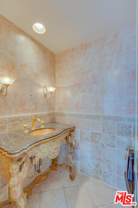 9255 Doheny Road, Unit 902 West Hollywood, CA 90069 - Photo 15 of 47 a bathroom with a sink and a shower