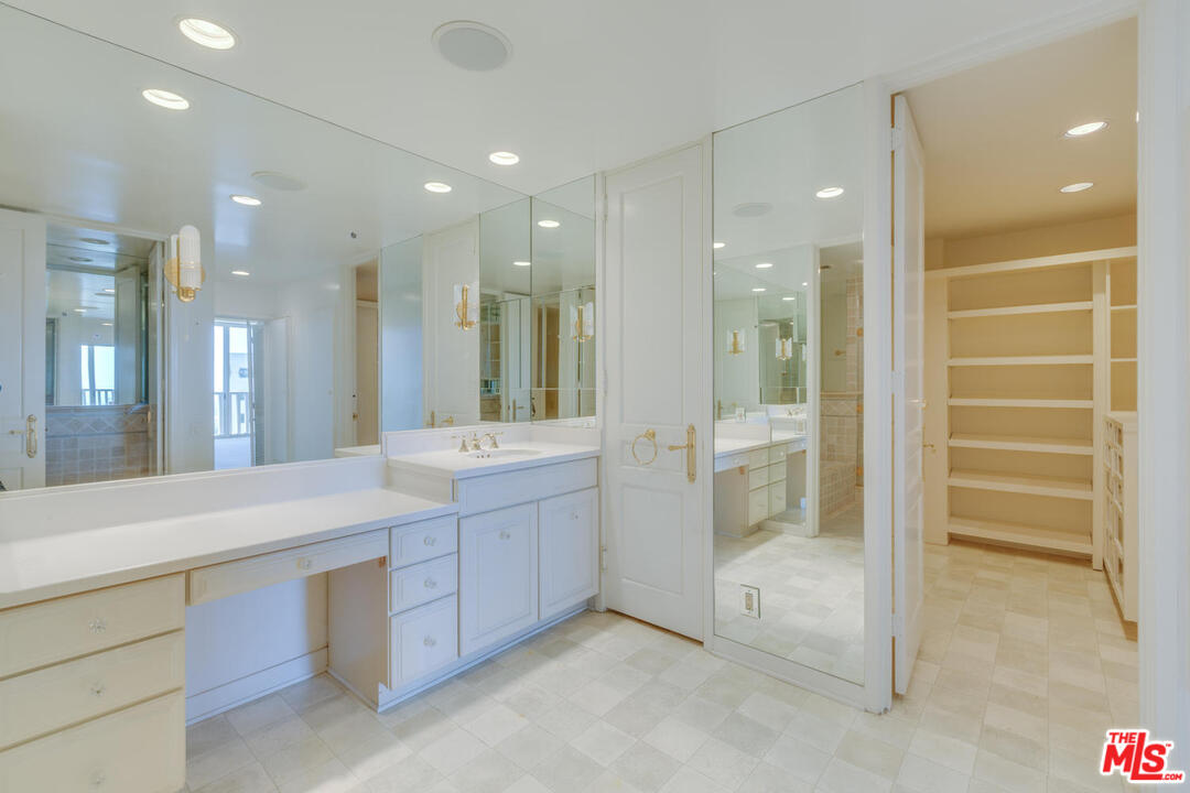 9255 Doheny Road, Unit 902 West Hollywood, CA 90069 - Photo 16 of 47 a bathroom with a double vanity sink and a mirror