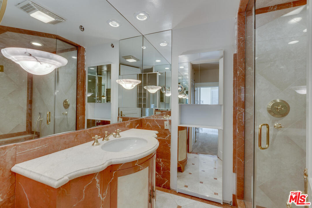 9255 Doheny Road, Unit 902 West Hollywood, CA 90069 - Photo 18 of 47 a bathroom with a sink shower and a mirror